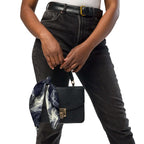 Smokey All-Over Print Bandana for Stylish Streetwear tied to a black purse with a fashionable outfit.
