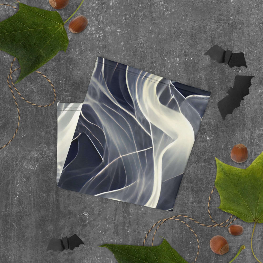 Smoke pattern gaiter displayed on a textured surface with leaves and bat decor, emphasizing versatility and style.