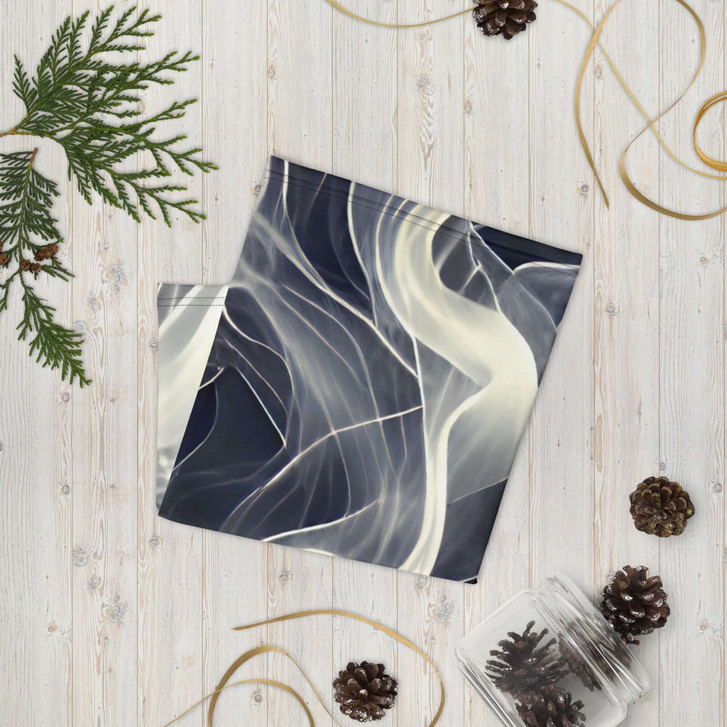 Smoke pattern gaiter displayed on a wooden surface, showcasing its smooth design and versatility as a neck warmer.