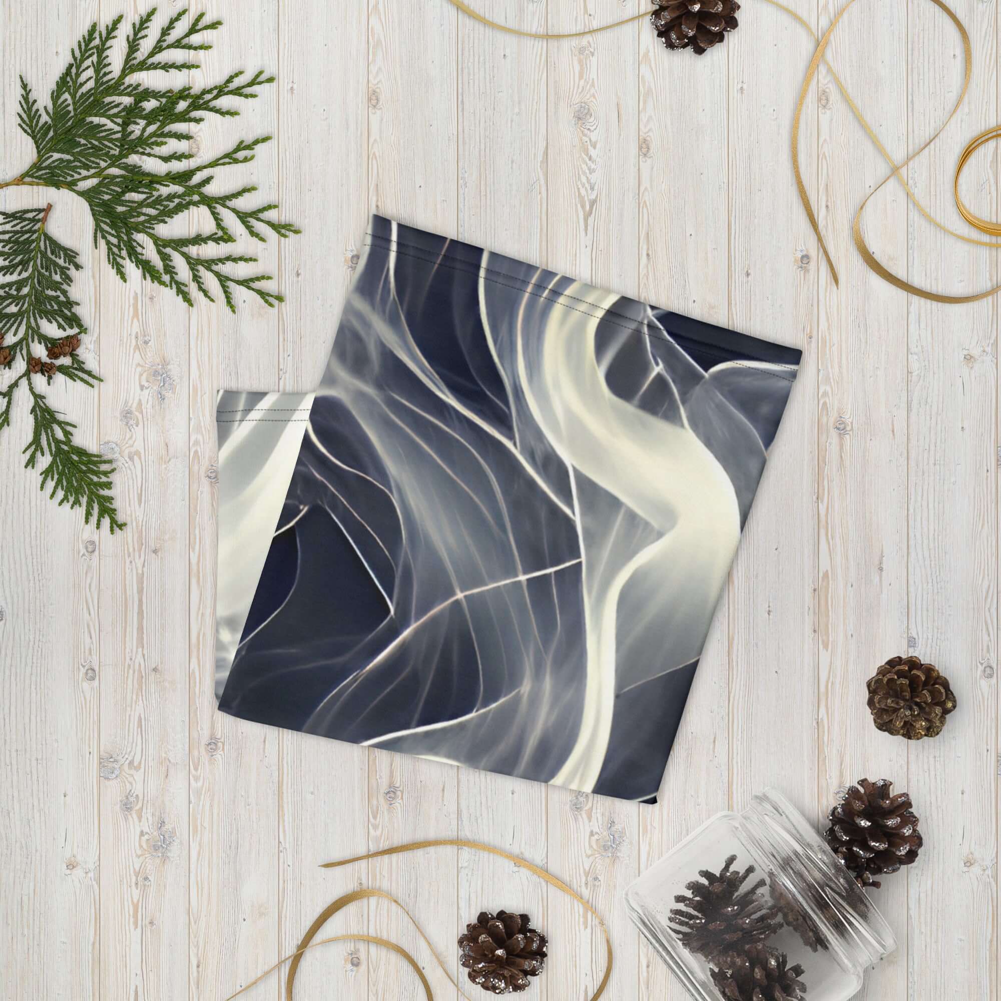 Smoke pattern gaiter displayed on a wooden surface, showcasing its smooth design and versatility as a neck warmer.