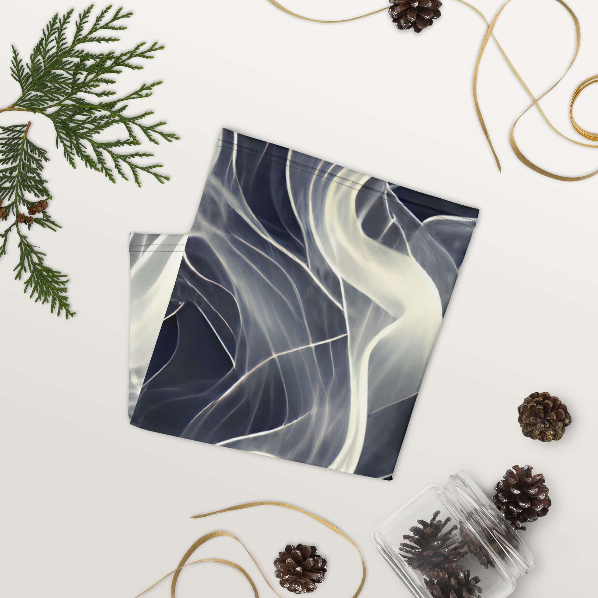 Smoke pattern gaiter laid flat on a surface, showcasing its unique design and versatile use as a neck warmer or face covering.
