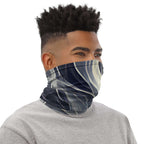 Smoke pattern gaiter worn as a face covering by a man with a stylish hairstyle.