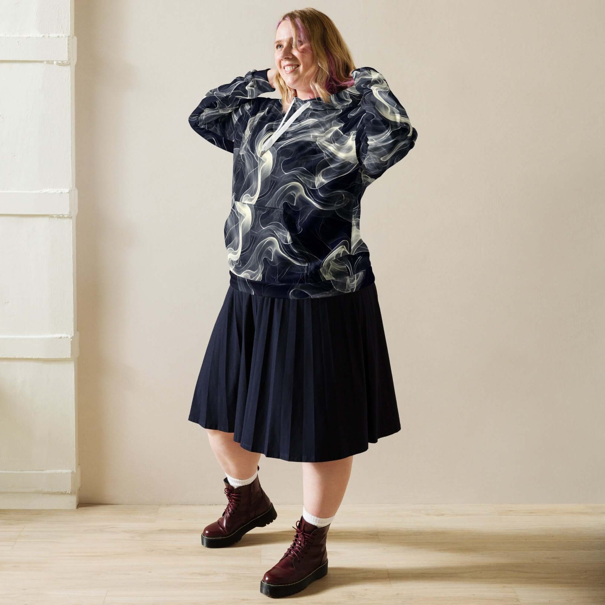 Smokey Unisex Hoodie for Stylish Streetwear Enthusiasts worn with a pleated skirt, showcasing an urban fashion look.
