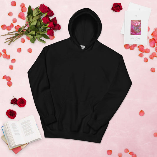 Lynxdonk Unisex Hoodie Cozy and Stylish Essential displayed with flowers and books on a pink background.