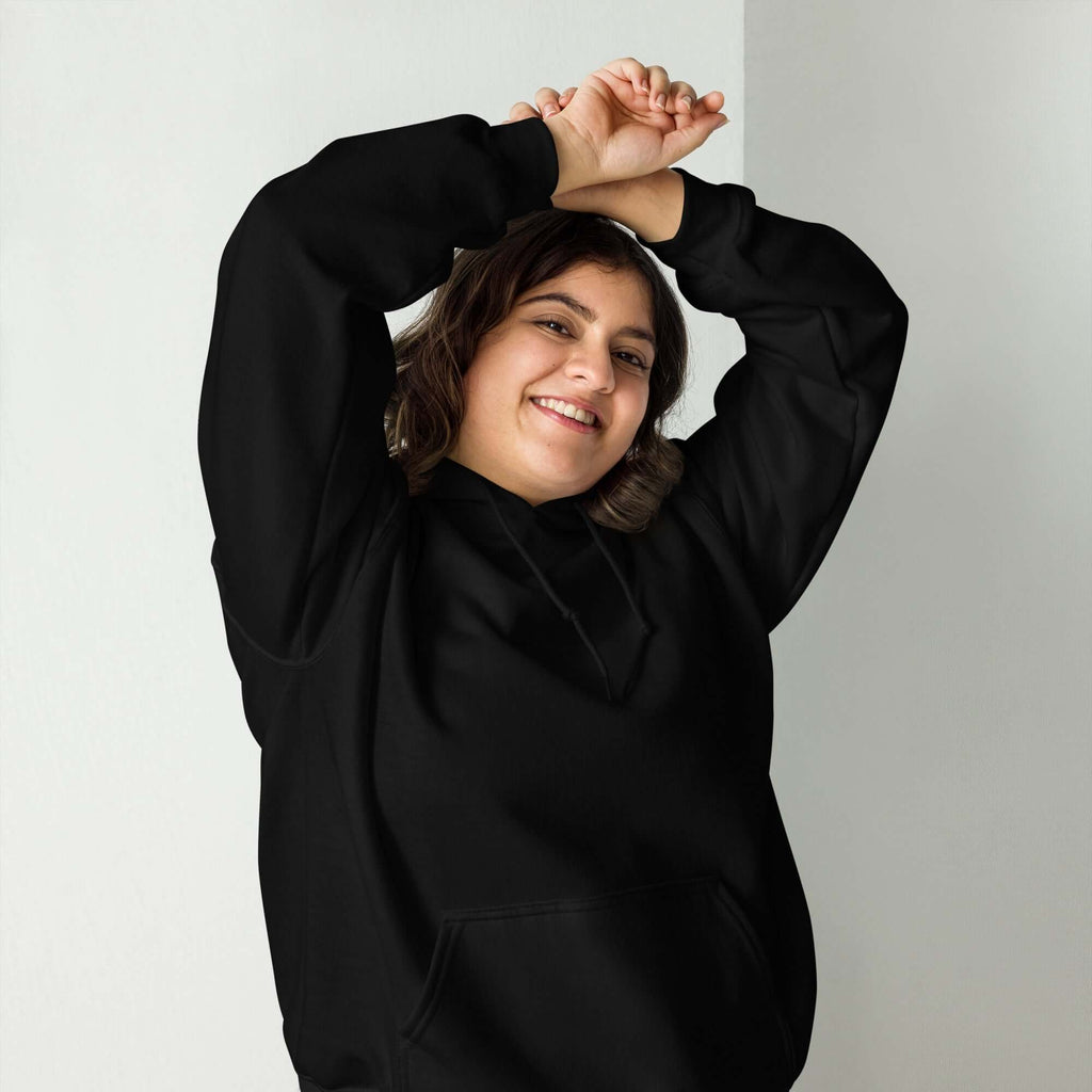 Lynxdonk Unisex Hoodie Cozy and Stylish Essential worn by a smiling person in a black hoodie.
