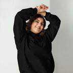 Lynxdonk Unisex Hoodie Cozy and Stylish Essential worn by a smiling person in a black hoodie.