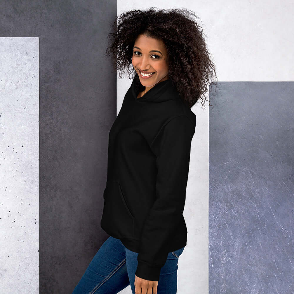 Lynxdonk Unisex Hoodie Cozy and Stylish Essential model wearing black hoodie with curly hair and smiling.