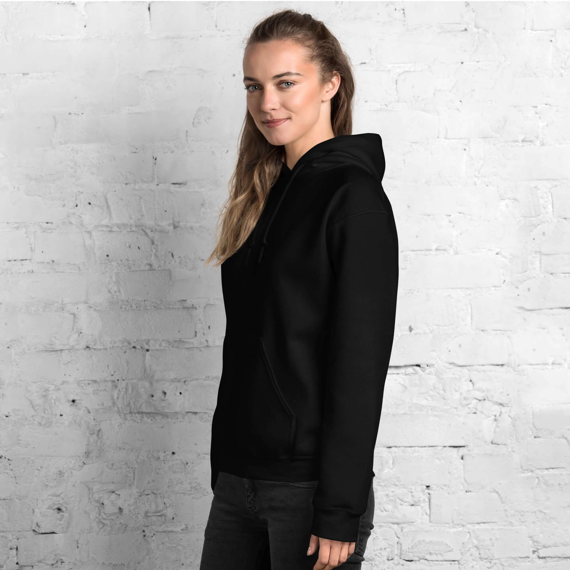 Lynxdonk Unisex Hoodie Cozy and Stylish Essential displayed on a model against a brick wall.
