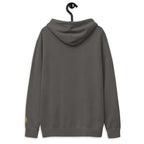 Back view of LynxDonkey Unisex pigment-dyed hoodie hanging on a display hook, showcasing its casual style.