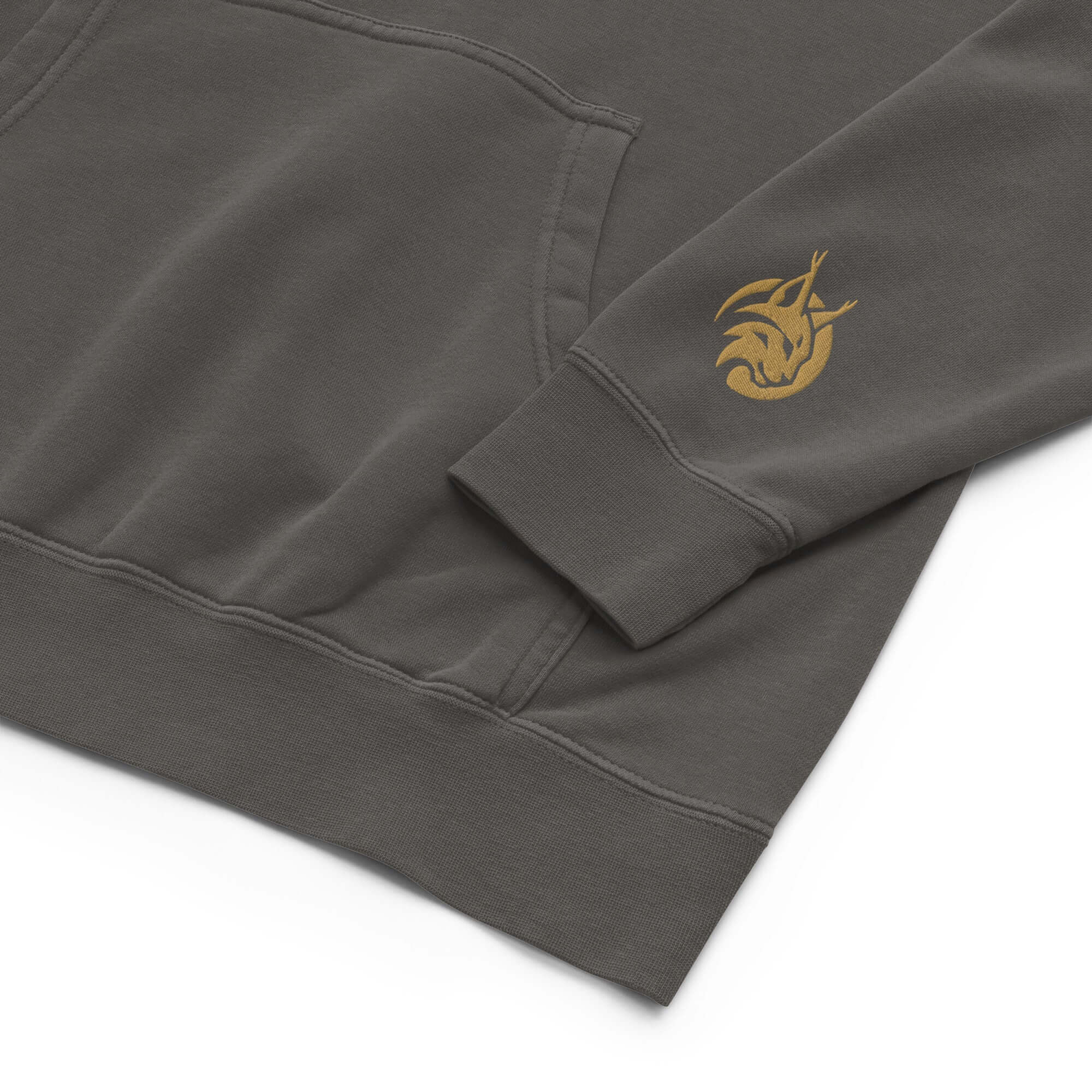 Close-up of LynxDonkey Unisex pigment-dyed hoodie showing the gold logo on the sleeve.